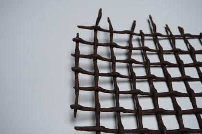 Section of rusted, bent iron lattice, view 8 of 9
