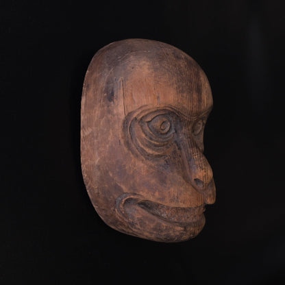 Hand-carved wooden monkey face mask mold with ringed eyes and a broad grin, view 4 of 8