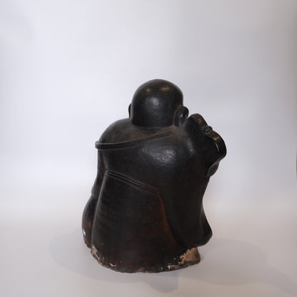 Laughing Buddha Hotei detail showing treasure sack symbolizing abundance