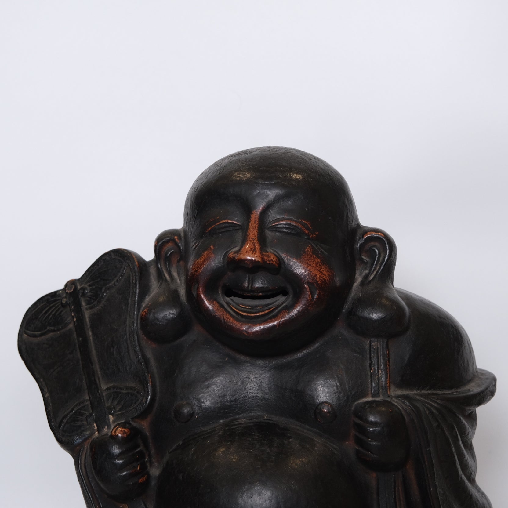 Three-quarter view of Edo period Japanese Hotei God of Happiness figure