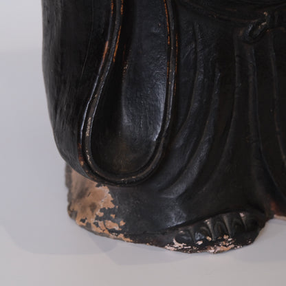 Close-up of Hotei face showing laughing expression and ceramic detailing