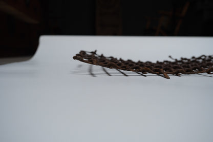 Section of rusted, bent iron lattice, view 7 of 9