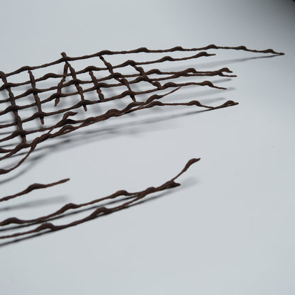 Section of rusted, bent iron lattice, view 3 of 9
