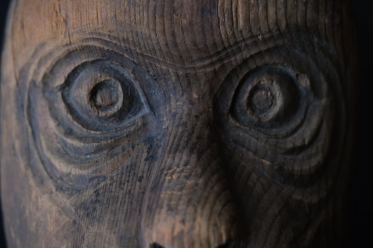 Hand-carved wooden monkey face mask mold with ringed eyes and a broad grin, view 6 of 8