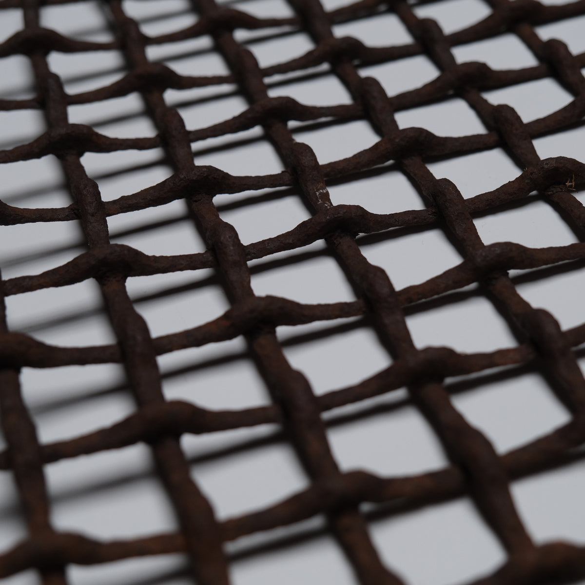 Section of rusted, bent iron lattice, view 5 of 9