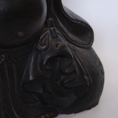 Detail of Hotei's robe and seated posture on late 18th century ceramic figure