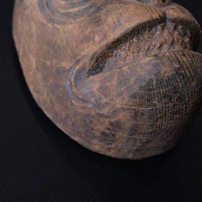 Hand-carved wooden monkey face mask mold with ringed eyes and a broad grin, view 3 of 8