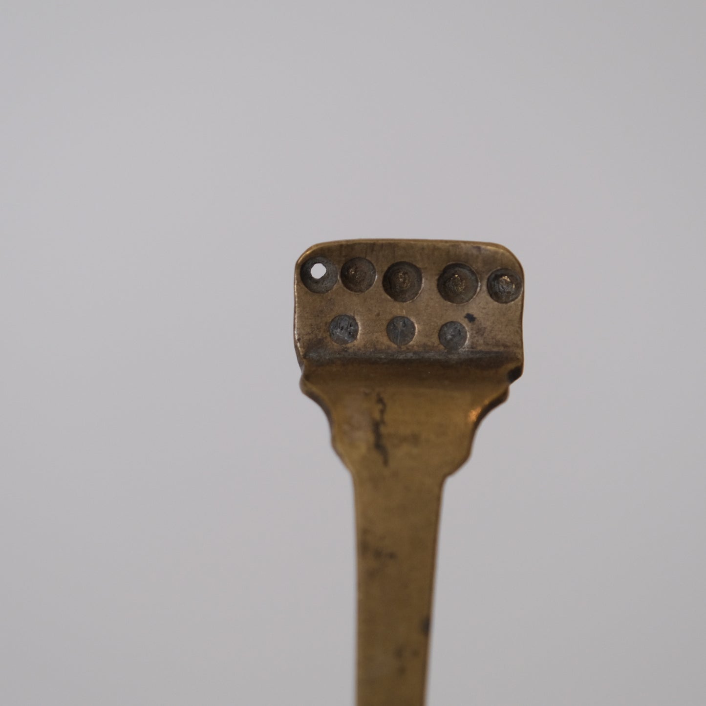 Full view of two Japanese Meiji period metal pill forms on contemporary stands
