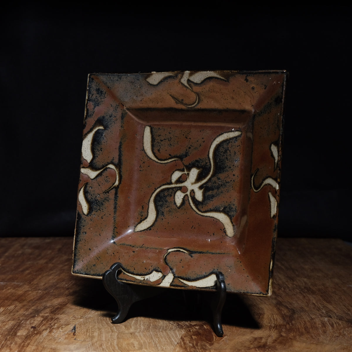Shoji Hamada square stoneware dish with kaki glaze and wax-resist floral design, view 1 of 12