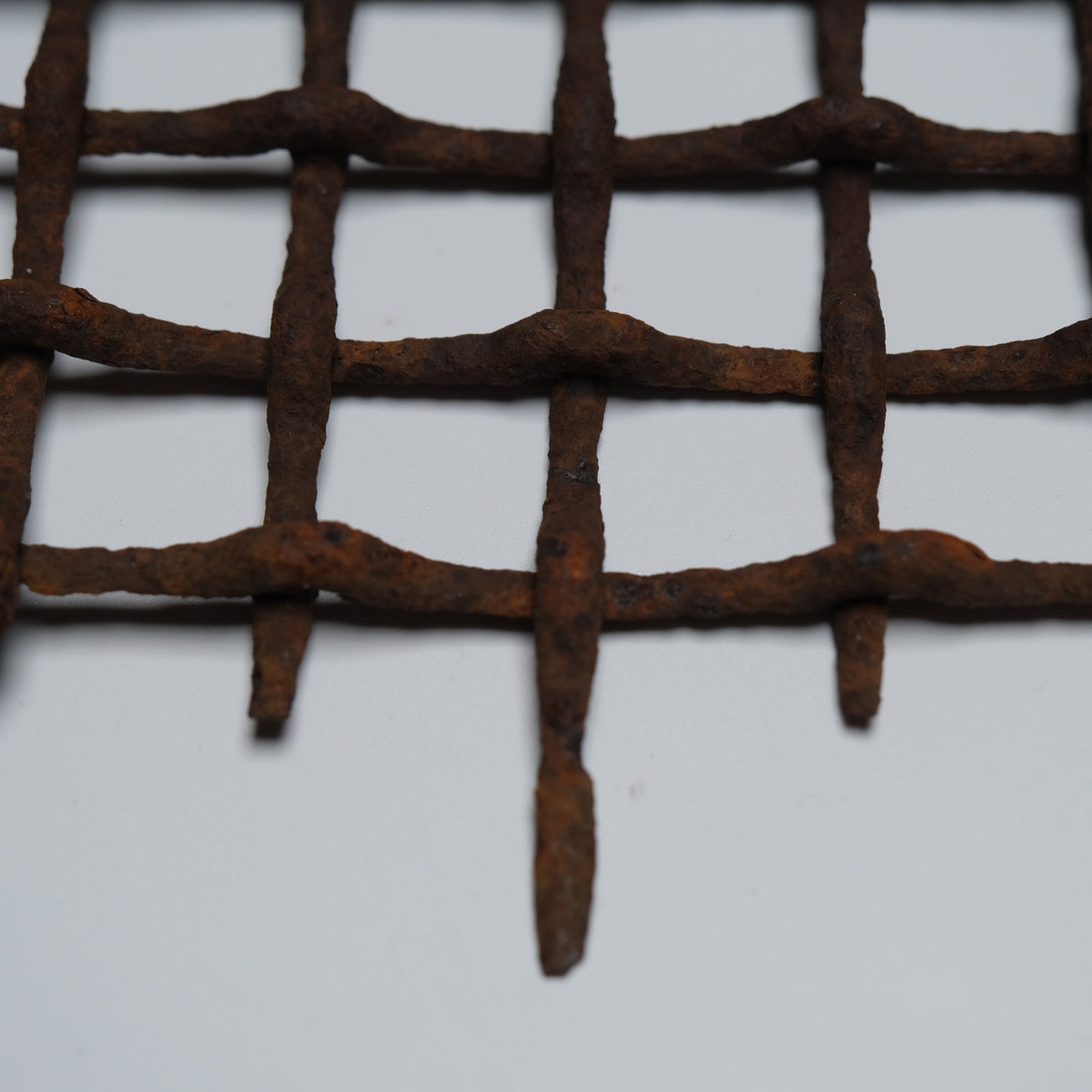 Section of rusted, bent iron lattice, view 4 of 9