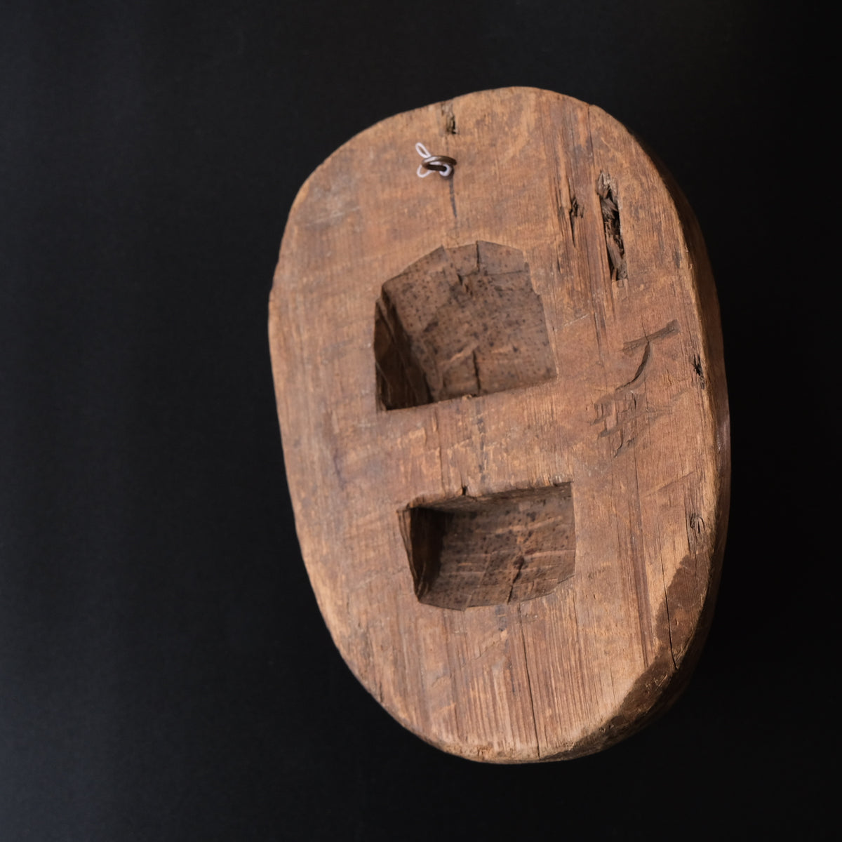 Hand-carved wooden monkey face mask mold with ringed eyes and a broad grin, view 2 of 8
