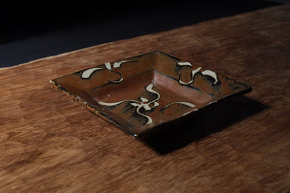 Shoji Hamada square stoneware dish with kaki glaze and wax-resist floral design, view 2 of 12