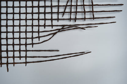 Section of rusted, bent iron lattice, view 9 of 9