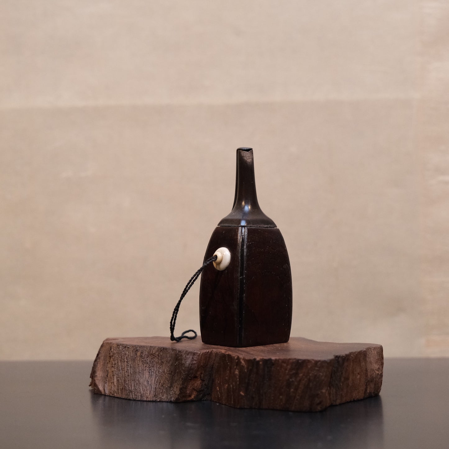 Antique gunpowder flask with horn body and carved stopper