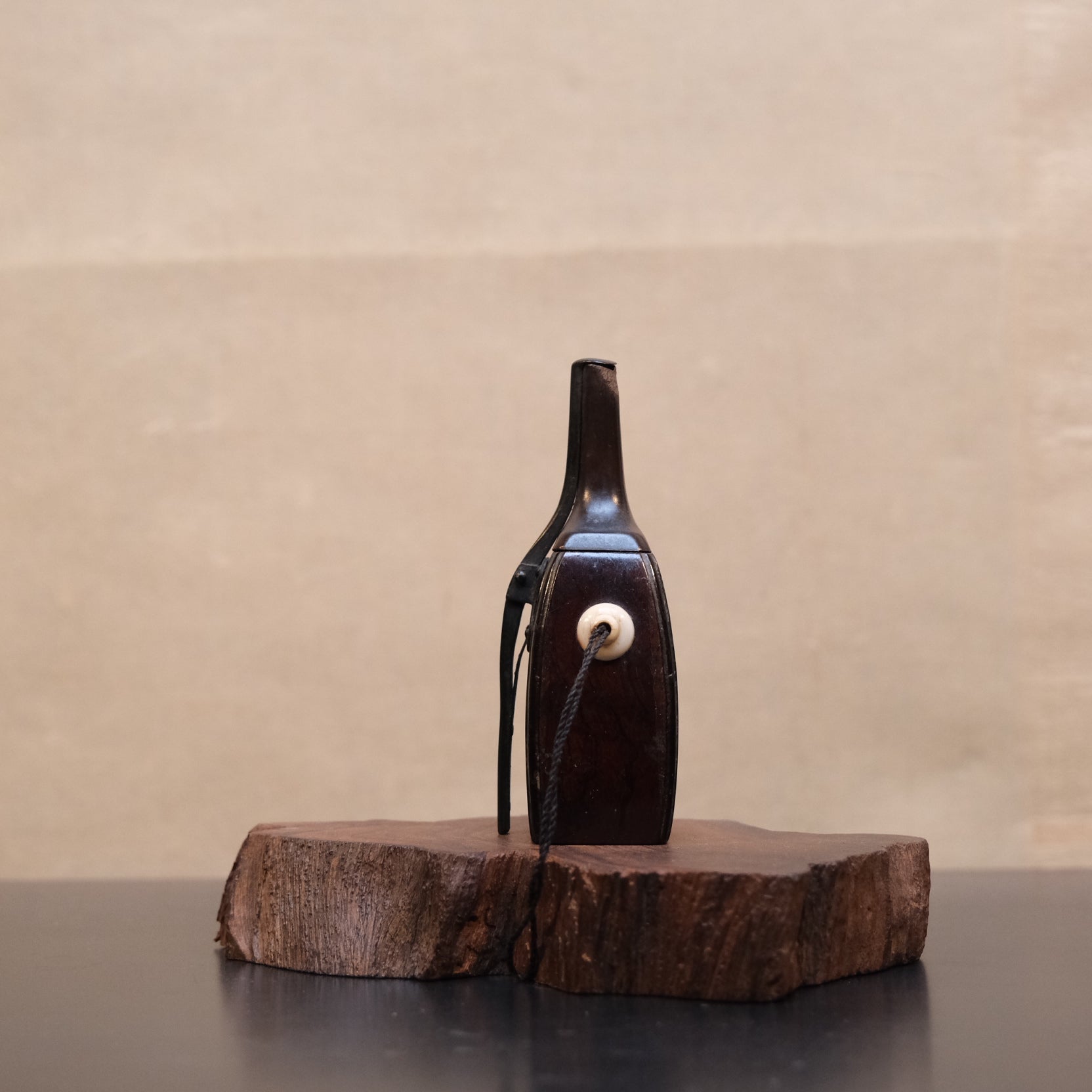 Detail of cord and bone hanging fitting on Japanese wooden gunpowder flask