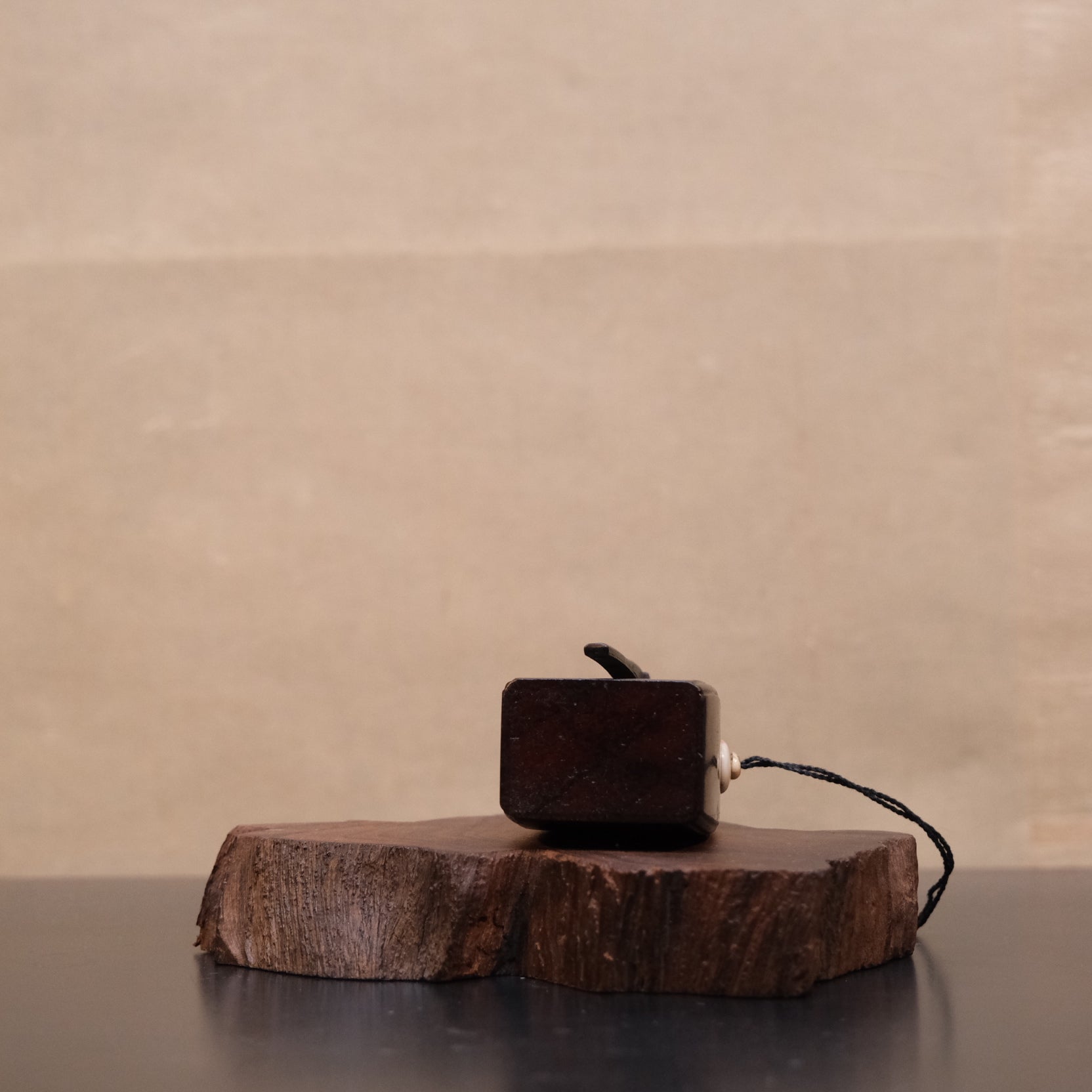 Three-quarter view of Japanese wooden gunpowder flask with bone fitting