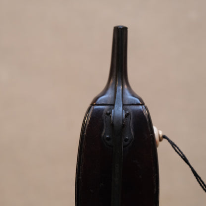 Side view of Japanese gunpowder flask showing rectangular tapering form