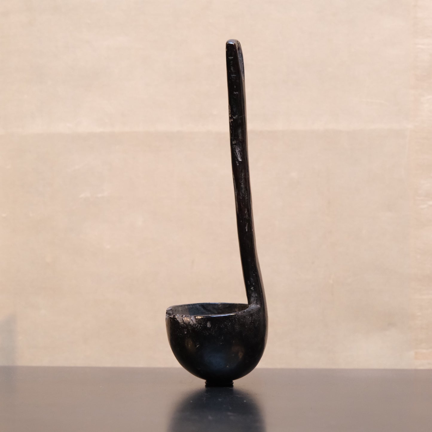 Carved wooden spoon with long handle, folk utensil