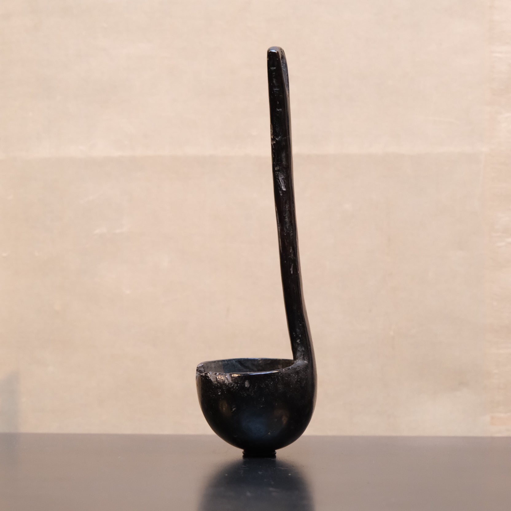 Carved wooden spoon with long handle, folk utensil