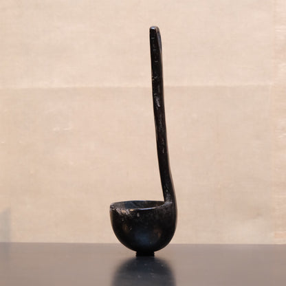 Carved wooden spoon with long handle, folk utensil