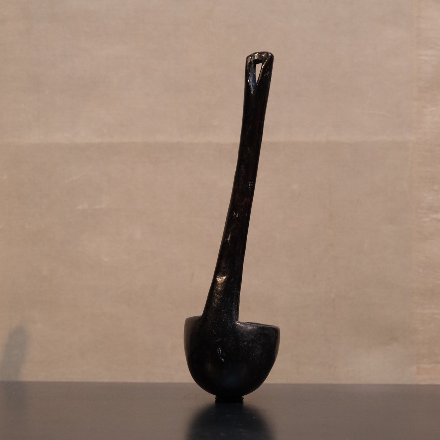 Handle detail on old Philippine folk ladle showing natural wood aging