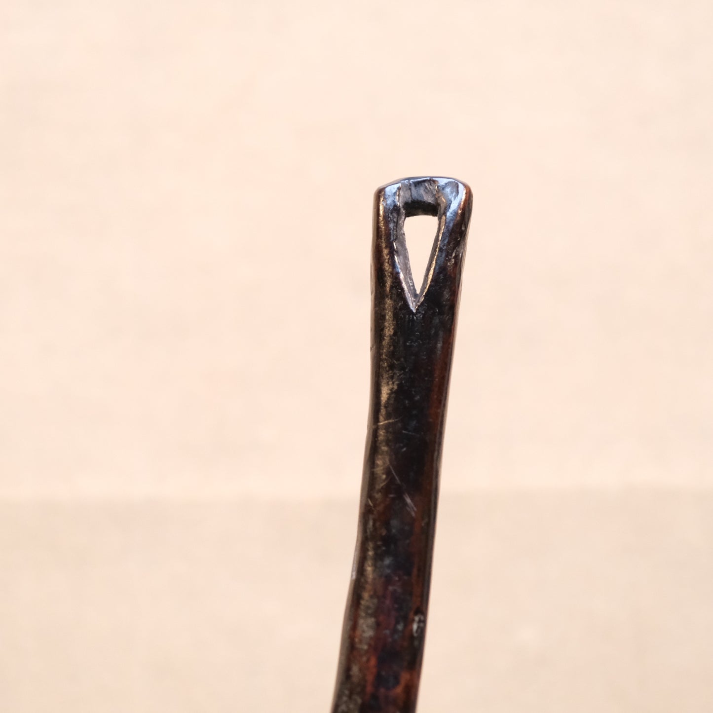 Three-quarter view of Philippine folk carved wood spoon with old patina