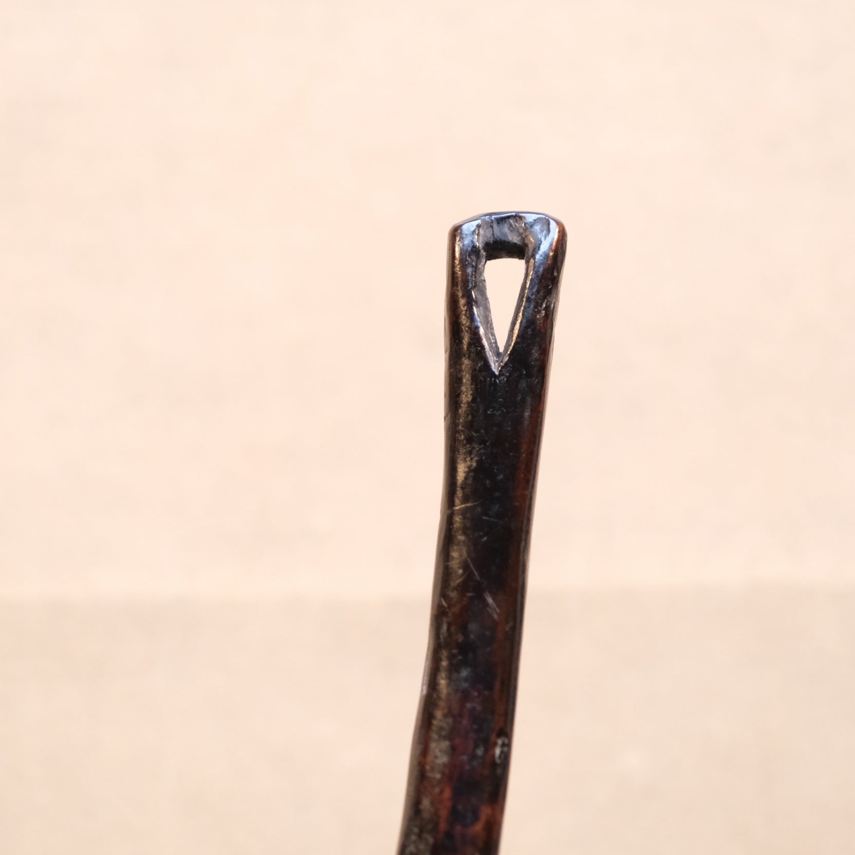 Three-quarter view of Philippine folk carved wood spoon with old patina