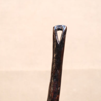 Three-quarter view of Philippine folk carved wood spoon with old patina