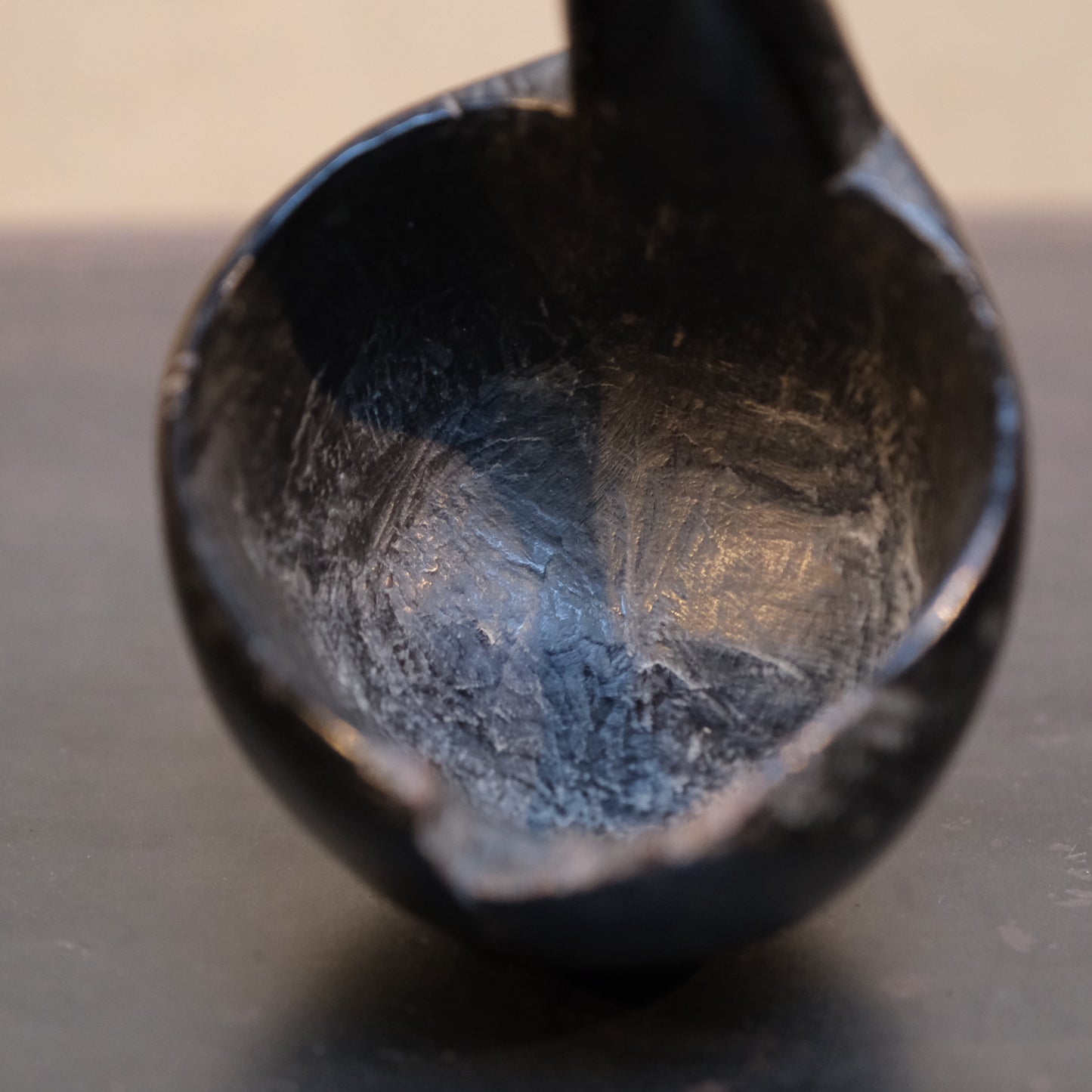 Side profile of Philippine folk ladle showing bowl depth