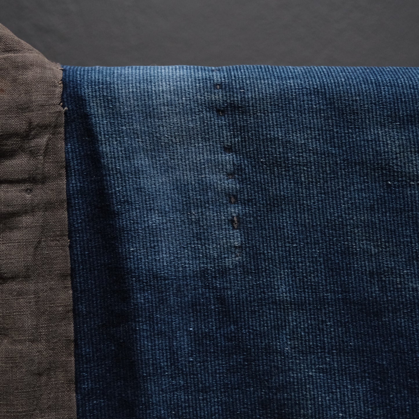 Sleeve area of Japanese noragi showing different indigo cotton fabric pieces