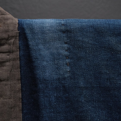 Sleeve area of Japanese noragi showing different indigo cotton fabric pieces