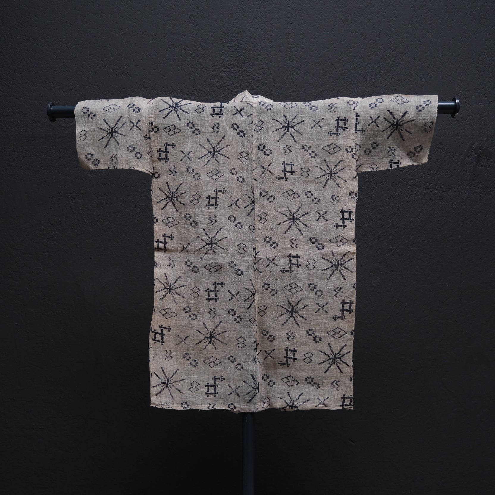 Japanese child's ramie summer kimono side view showing Okinawan stencil-dyed motifs