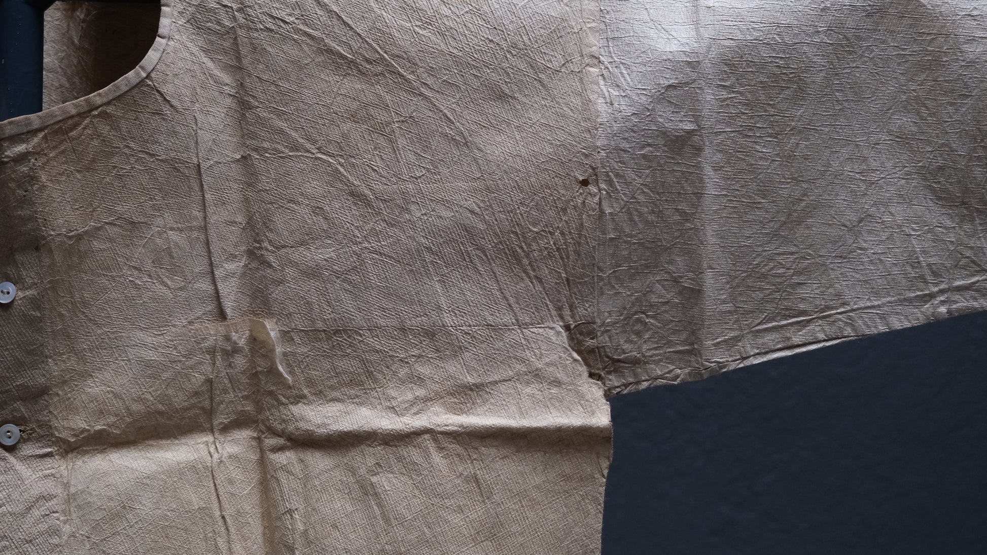 Alternate angle of Japanese kamiko paper garment showing washi paper surface