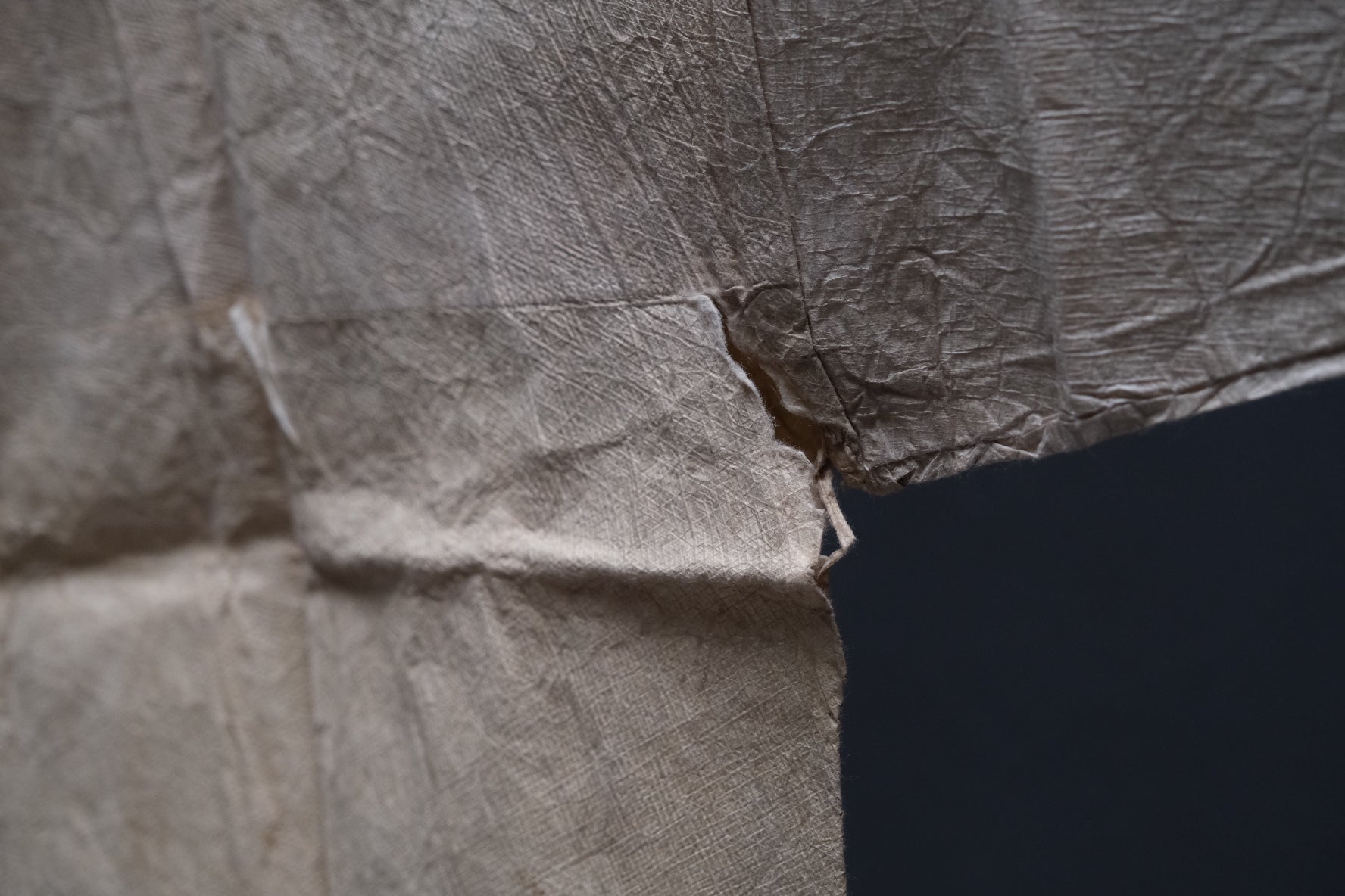 Body fold and stain detail on fragile Edo period kamiko paper shirt