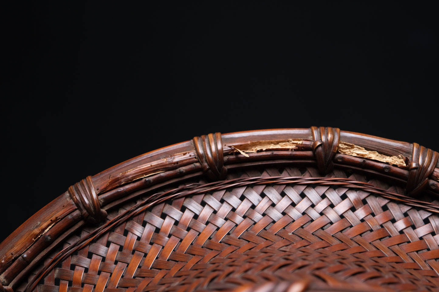 Base of Japanese bamboo flat basket showing original construction and patina