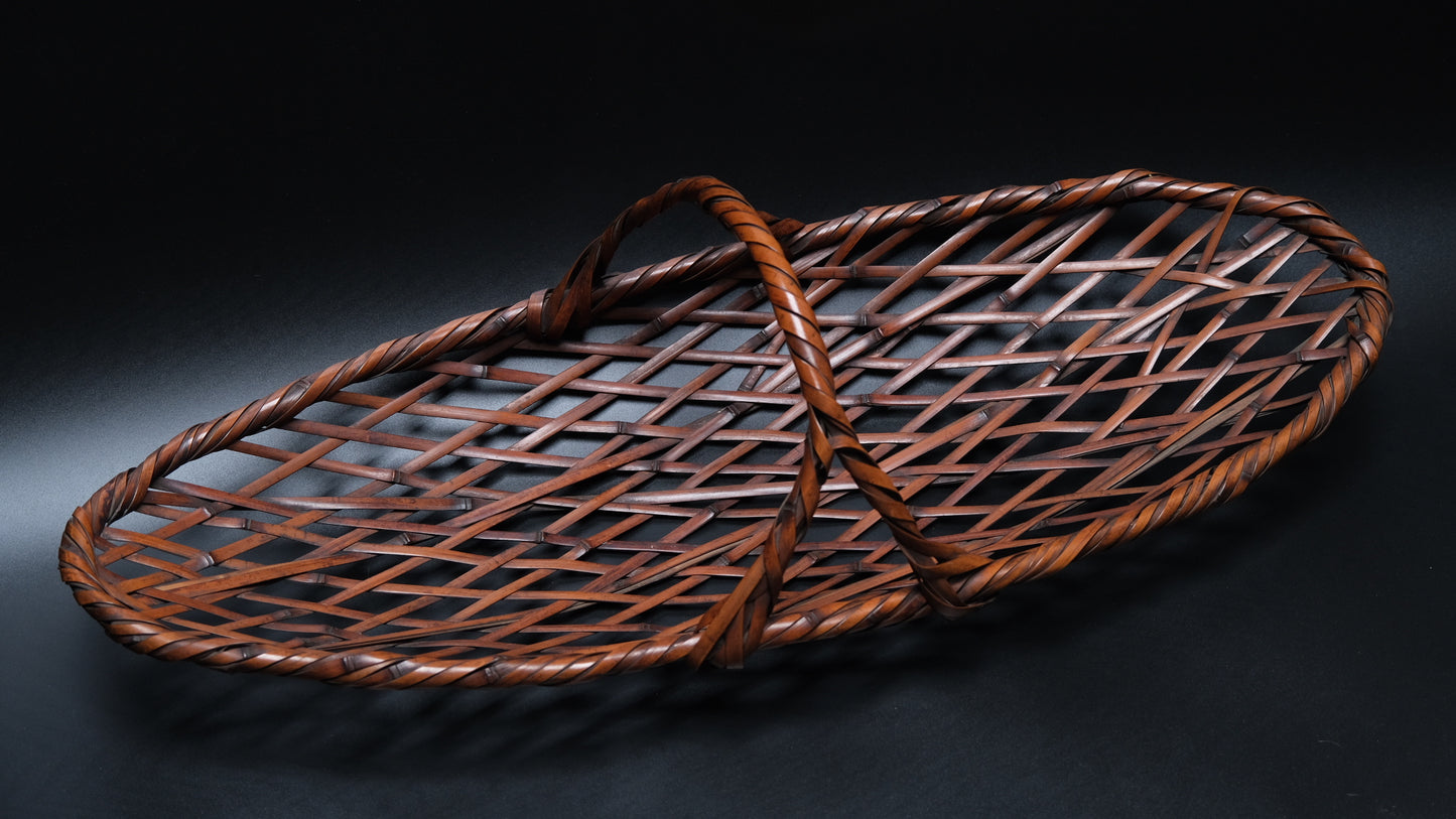 Close-up of artist's signature on bottom of signed Japanese madake basket