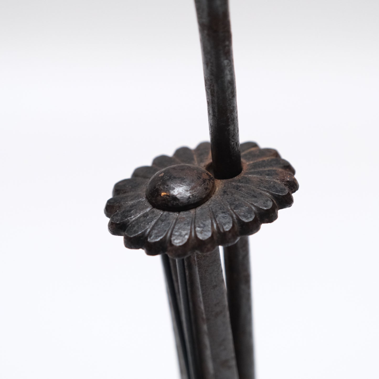 Alternate angle of Edo period Japanese iron kiku tansu lock on metal stand