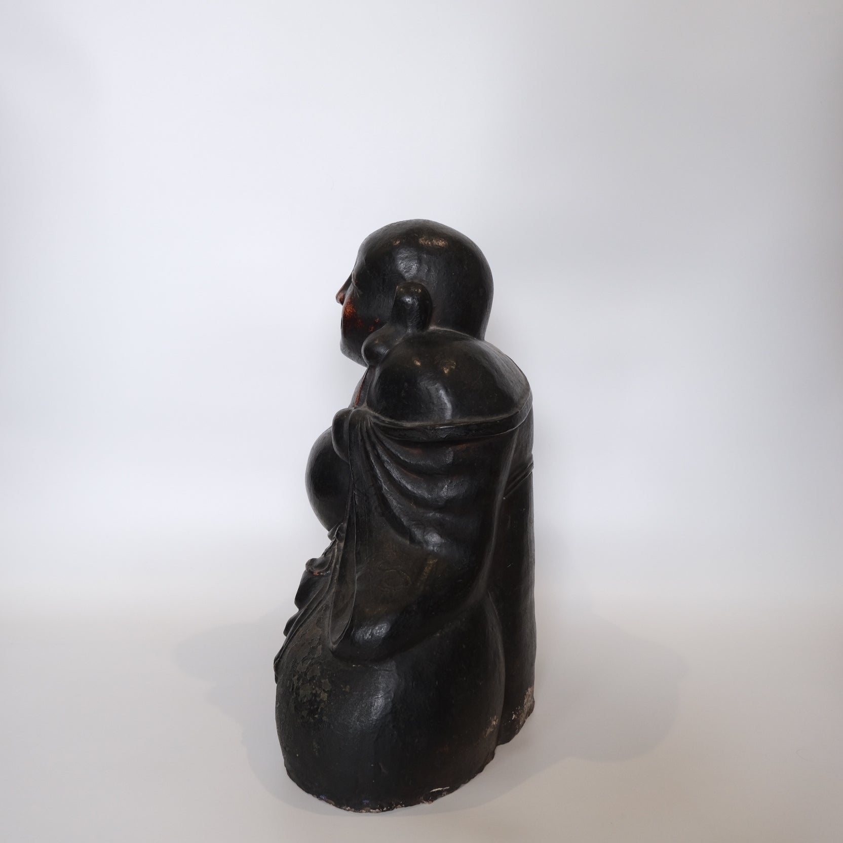 Reverse of large Hotei ceramic figure showing back detail and mounting