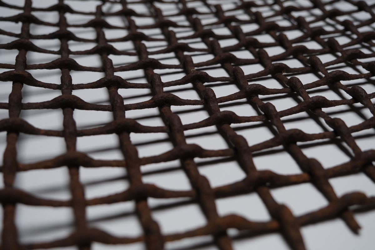 Section of rusted, bent iron lattice, view 6 of 9