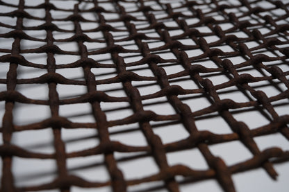 Section of rusted, bent iron lattice, view 6 of 9