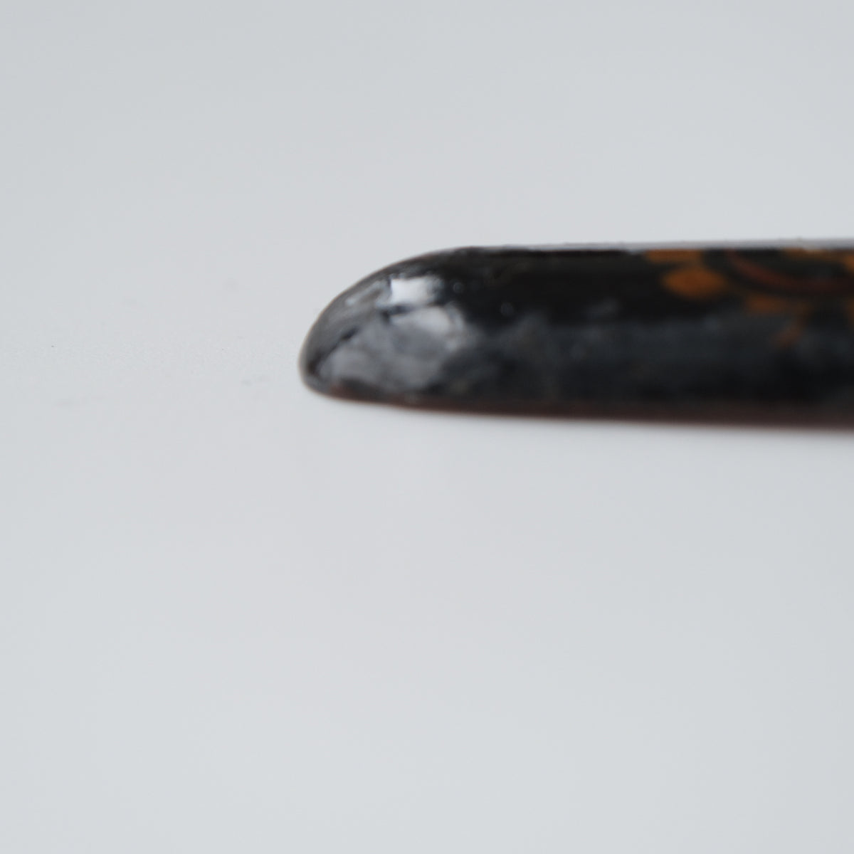 Ainu ikupasuy prayer stick in black lacquer painted with scrolling stems, red commas and gold rosettes, view 9 of 12